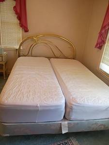 lot 910 image: Queen Sized Headboard and Box Springs.  Mattress is 2 Twin Sized Mattresses.   Headboard 46 x 56.  Located upstairs