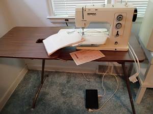 lot 922 image: Bernina 830 Sewing Machine with Adjustable Sewing Table.   Also has extra LED Lights under machine.   Table is 27 x 45 x 19 and when Raised 29.5 x 45 x 19.  Located upstairs