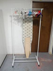 lot 950 image: Clothing Rack with Hangers and Ironing Boards.  Rack is 68 x 34.  Located in the basement