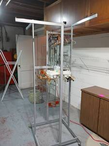 lot 953 image: Clothing Rack on wheels with Hangers.   75 x 29 x 29.   Located in basement
