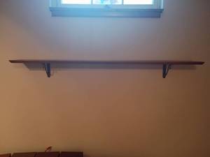 lot 982 image: Wooden Shelf.  51in long.  Will need to be removed from wall.   Located in basement