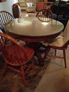 lot 1000 image: Round Table with Glass Top and 4 Chairs.  30 x 45.  Located in basement
