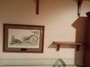 lot 1004 image: Small Wooden Shelf with Picture of The 1042 Train.  Signed and Numbered.   Shelf is 18in. long and Picture 16 x 23.  Located in basement