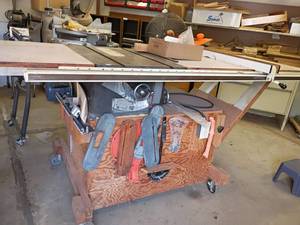 lot 1025 image: Delta Table Saw with Work Table on Wheels with Contents   Approximately 37 x 68 x 35