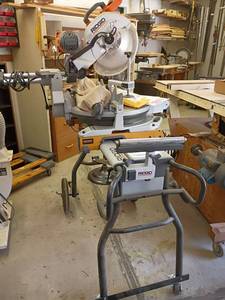 lot 1026 image: Ridgid 12in. Sliding Compound Miter Saw with Exactline Laser on Wheels.    Approximately 68 x 44 x 57