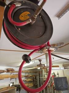 lot 1031 image: Air Compressor Hose and Reel.  Will need to take down.  Bring ladder and tools.