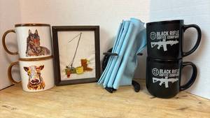 lot 1469 image: Black Rifle Coffee Company Mugs, Animal Print Mugs, Framed Needlework, Napkins & Horseshoe Holder