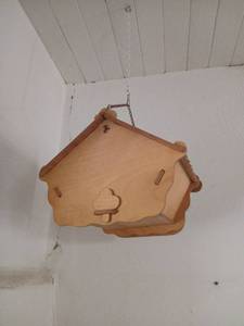 lot 1617 image: Hanging Birdhouse with Wooden Carved Design and Metal Chain Must bring step ladder or ladder to remove from ceiling hooks and container to put items in.