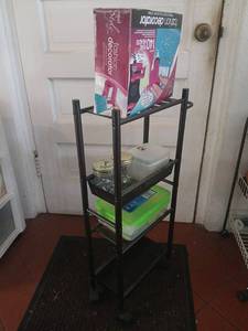lot 1623 image: 4-Tier Metal Storage Shelving Unit with Black Frame on wheels, 28x16x6, with embellishments