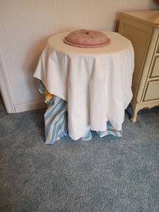 lot 2007 image: Small Round Table, Glass Top with Table Cloths and a Clock. Table 25 x 20.  Clock is 11in diameter