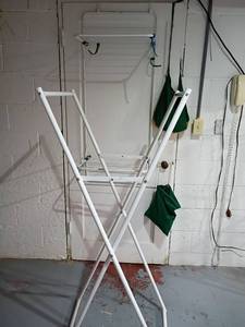 lot 3001 image: Over the Door Drying Rack and a Free Standing Drying Rack.  Comes with clothes pins.  Free Standing 62 x 21.   Located in basement