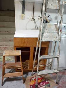 lot 3003 image: Cabinet with No Doors with Metal Step Ladder and Wooden Step Ladder.  Cabinet 35 x 27 x 24.5.  Located in basement