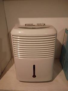 lot 3007 image: GE Dehumidifier.  Located in basement