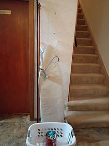 lot 3028 image: Ironing Board, Laundry Basket, Curtain Rods, Hooks and More.   Located in basement