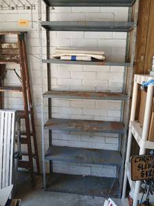 lot 4001 image: Metal Shelving Unit 4-Shelfwill need removed from wall, 84x36x1 with miscellaneous  metal  signs
