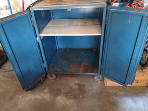 lot 4114 image: Wooden Storage Trunk with Metal Strap and Contents metal cabinet with key on wheels, 42x30.5x26. Buyer removes