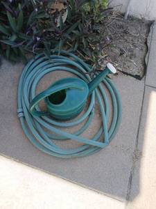 lot 5072 image: Garden Hose with Watering Can