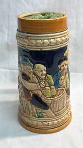 lot 51 image: German Beer Stein with Relief Figures and Decorative Handle