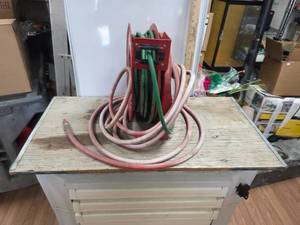 lot 257 image: Retractable air hose reel attached to board