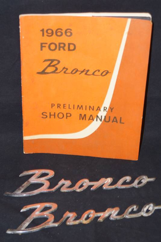 lot 316 image: 1966 Ford Bronco Shop Manual and 2 Bronco Emblems- Vintage Ford Items