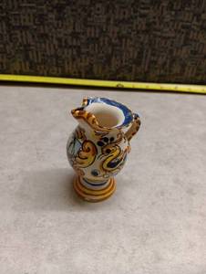 lot 2048 image: Hand-Painted Ceramic Pitcher with Decorative Scrollwork and Boat Motif