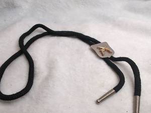 lot 3506 image: Bolo Tie with Crossed Pistols Clasp and Black Cord