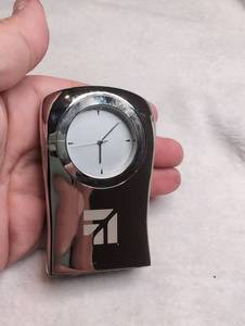 lot 5012 image: Miniature Desk Clock with Stylized Logo Polished Dark Finish