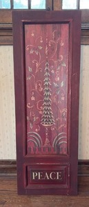 lot 2008 image: Wood Panel with Peace Text and Decorative Tree Design. Hanging Hardware on Back (Approximately 46 Inches by 15 inches)