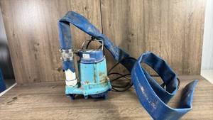 lot 410 image: 50700 Submersible Sump Pump with Discharge Hose-powers on