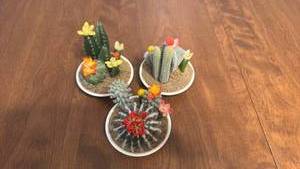 lot 11 image: Artificial Flowering Cactus Arrangement Set of 3