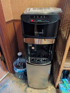lot 1090 image: Primo Water Cooler Dispenser with Bottom Load Cabinet and bottle