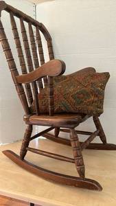lot 1123 image: Childs Wood Spindle Rocking Chair with pillow