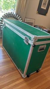 lot 1128 image: Green Storage Trunk with Wheels and Metal Banding31 12 inches tall, 45 inches wide and 17 inches deep