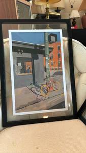 lot 1134 image: Framed Print Urban Street Scene with Red Bicycle and Orange Building with extra frame - 21 x 15