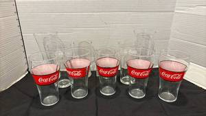 lot 1300 image: Coca-Cola Drinking Glasses Set of 5 with Red Branding Band along with other glasses