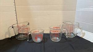lot 1315 image: Pyrex Measuring Cups Set 4 Piece Glass Red Print