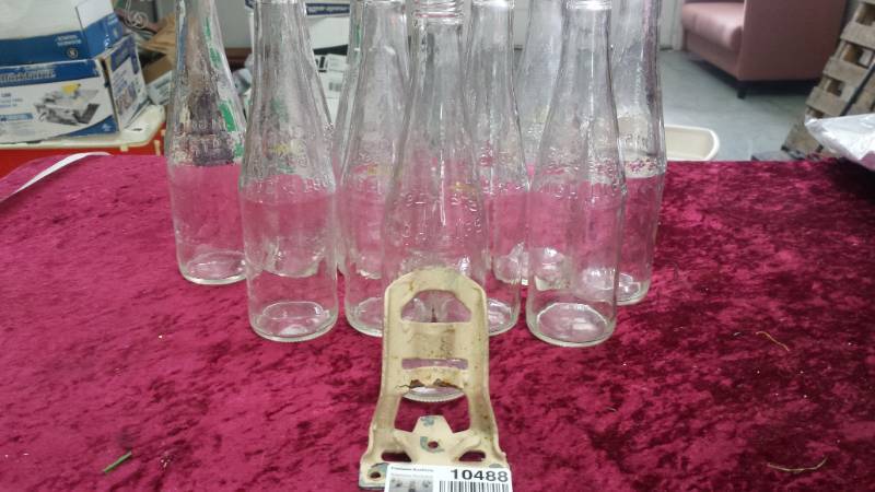 lot 10488 image: Bottles and Iron Flag Pole Holder
