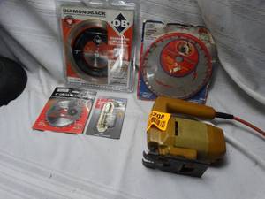 lot 25208 image: Yellow vintage style jigsaw and multiple circular saw blades
