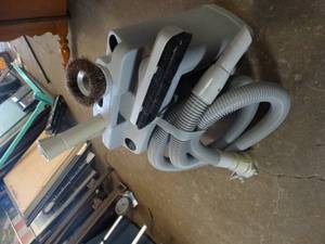 lot 27864 image: Kirby Vacuum Cleaner Accessory Storage Caddy containing hose and various cleaning attachments