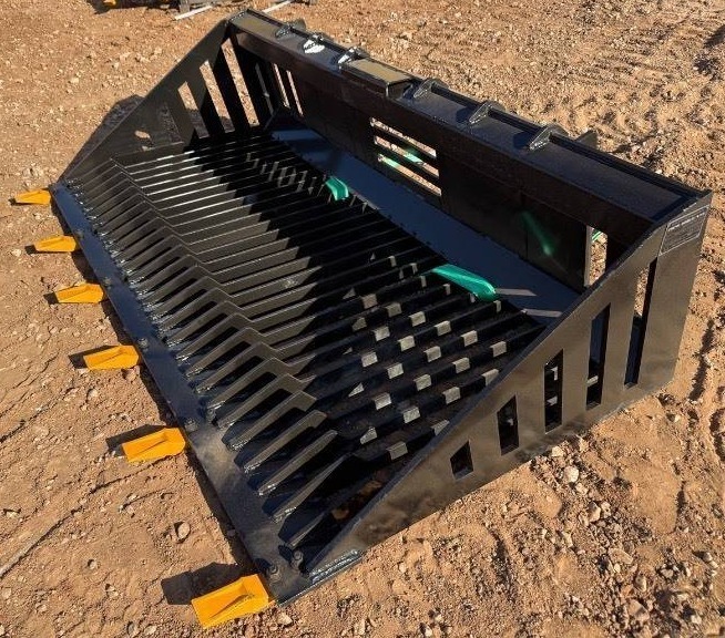 lot 8625 image: Captok model CK-RB66 rock bucket attachment designed for skid steer loaders. Constructed for heavy-duty rock handling and material sifting with durability and strength