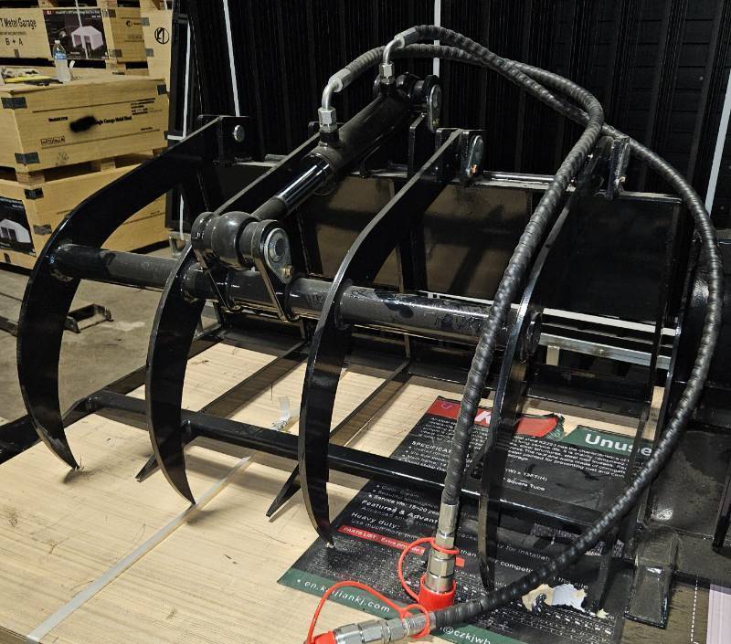 lot 5609 image: Unused Industrial-Grade Hydraulic Grab WoodHay Fork Attachment Designed for Mini Skid Steer Loaders - Hardened Steel Tines Penetrate Wood Piles