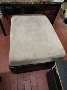 lot 63101 image: Upholstered Beige and Black Vinyl Ottoman
