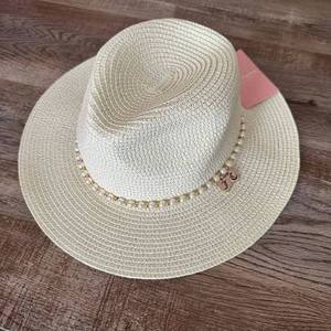 lot 63221 image: Juicy Couture woven straw hat