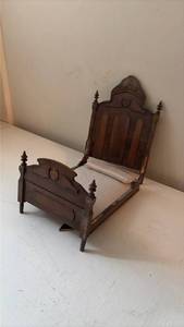 lot 163 image: Wooden Dollhouse Bed with Carved Headboard and Footboard