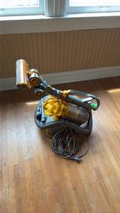 lot 246 image: Dyson Canister with Telescoping HandlePowers Up, Need Cleaned Up, Has Retractable Cord That Needs Fixed - All Easily Done at Home