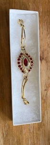 lot 324 image: Gold Tone Bracelet with Red Faceted Stones and Matching Earrings