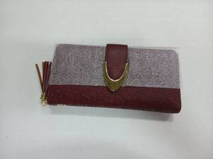 lot 8375 image: burgundy and glitter clutch wallet features a prominent gold-tone buckle closure and a matching side tassel.