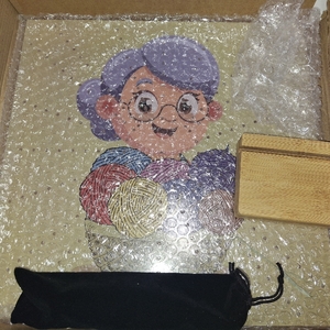 lot 13342 image: Grandmas Knitting World puzzle or similar punch needle kit featuring a cartoon character.