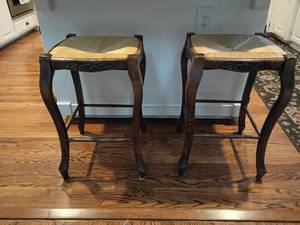 lot 920 image: 2 Wooden Barstools.  Wicker Seat and Hand Carved Sides.   24 x 15 x 15