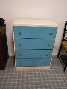 lot 930 image: White Chest of Drawers.   Drawers are painted blue.   Top needs repair.    Located in basement.    34 x 26 x 14